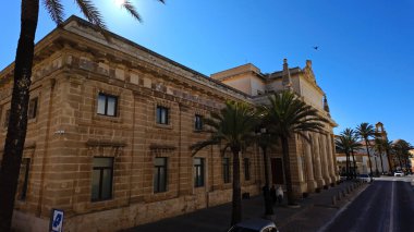 Cadiz Müziği Konservatuvarı, İspanya 'nın Cadiz şehrinde palmiye ağaçları ve açık mavi gökyüzü ile güneşlenirken - CADIZ, İspanya - 26 Mart 2025