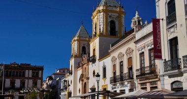 Nuestra Kilisesi 'nin beyaz cephesi Senora de la Merced Ronda' da mavi gökyüzüne karşı duran iki kulesiyle - RONDA, SPAIN - 28 Mart 2025