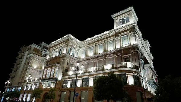 SEVILLE, SPAIN - 25 Mart 2025 'te Sevilla' daki tarihi bir binanın aydınlatma açısı düşük.