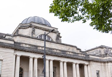 Kubbesi ve sütunlarıyla Ulusal Müze Cardiff, aşağıdan, bir ağaç ve bir sokak lambasıyla görülüyor.