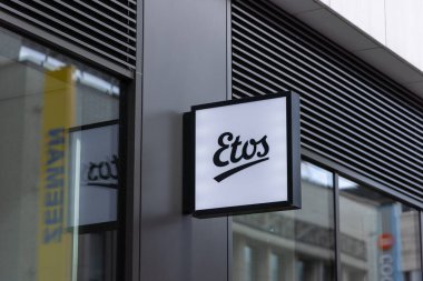 ROTTERDAM, NETHERLANDS - 13 Eylül 2025 - Rotterdam 'daki modern bina cephesinde asılı duran Etos aydınlatma işareti. ROTTERDAM, NETHERLANDS - 13 Eylül 2025 -