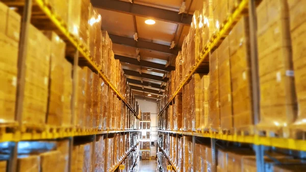 A large warehouse, with high racks, full of goods. storehouse in the enterprise, factory. High quality photo