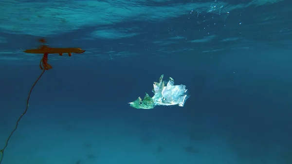 close-up of a plastic bag floating in the sea. Garbage in the sea water. Environmental Pollution of plastic rubbish pollution in oceans and seas. Environment, Pollution concept. High quality photo