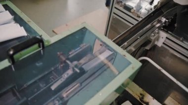 Empty aluminum containers, tubes. Aluminum tubes are filled with hair dye and sealed with special automatic equipment in a chemical factory.