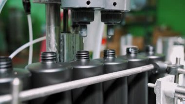 Empty plastic containers, tubes. Plastic tubes are filled with hair dye and sealed with special automatic equipment in a chemical factory.