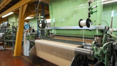 Dokuma tezgahı. Tekstil fabrikası ekipmanı. Otomatik dokuma makinesi iplik kumaşı üretiyor. Dokuma fabrikası. Tekstil endüstrisi. kumaş üretimi. 