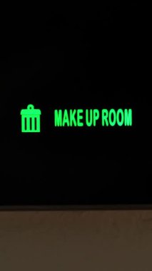 Make up room. close-up. the sign is lit in green. electronic plate. External indicator. a digital board with an inscription - make up room. in the hotel room