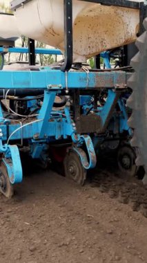 Tohum ekiciyle birlikte Traktör 'ün yakınına. Mısır ekme, toprağa mısır ekme, bahar mevsiminde pnömatik ekme makinesi. Tohum ekici ile traktördeki çiftçi tarlayı işliyor.