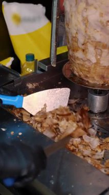 Bir aşçı et keser, shawarma, jiroskop, döner kebap yapmak için. Şişte et pişirmek