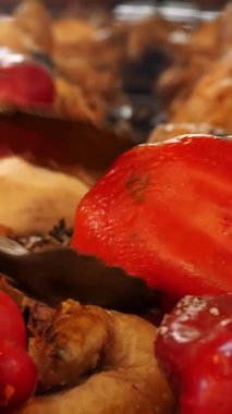 Yanan kömürlerin üzerinde ızgara et. Izgara sebze. Yakın plan. Kızarmış kaburgalar ve sulu kırmızı biberler kömürün üzerinde barbekü ızgarasında kızarıyor. Izgara yemek, bbq, barbekü.