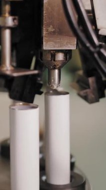 Empty aluminum containers, tubes. Aluminum tubes are filled with hair dye and sealed with special automatic equipment in a chemical factory.