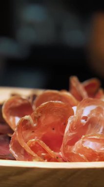 Et çerezi. jamon. Lezzetli et aperatifleri Prosciutto Crudo veya ahşap tabakta biberiyeli jamon eti. Şef servis masasına jamon koyar..