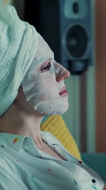 Pijamalı kız gece yatak odasında dizüstü bilgisayardan video izliyor. portre