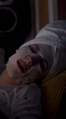 Pijamalı kız gece yatak odasında dizüstü bilgisayardan video izliyor. portre