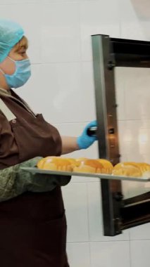 Yemek pişirmek. Yakın plan. Mutfak işçisi, koruyucu eldivenlerle, elektrikli öğütücüye taze lahana kesiyor. Sağlıklı yemek. Covid-19 'dan sonra tekrar açılıyor. Güvenlik kavramı. Gönüllülük ve yardım.