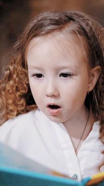 Child reads a book. mom daughter. cute little girl. mom and little daughter spend time together, read a book together, have fun. family
