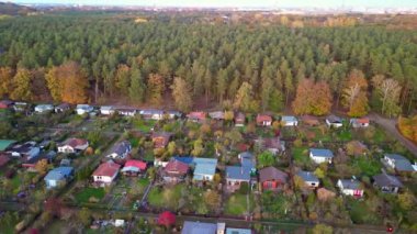 wide orbit overview drone Allotment gardens berlin teufelsberg, autumn evening sunset 2022. High Quality 4k Cinematic footage