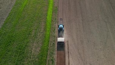 pursuit flight drone tractor on fall field brandenburg havelland Germany at autumn 2022. High Quality 4k Cinematic footage