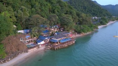 fly reverse drone white Sand Beach koh chang island Thailand, evening golden hour 2022. High Quality 4k Cinematic footage.
