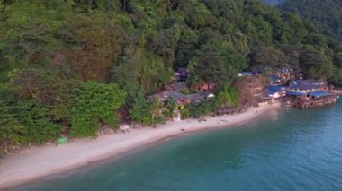wide orbit overview drone white Sand Beach koh chang island Thailand, evening golden hour 2022. High Quality 4k Cinematic footage.