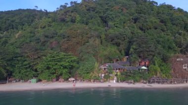 boom sliding to right drone white Sand Beach koh chang island Thailand, evening golden hour 2022. High Quality 4k Cinematic footage.