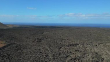 panorama overview rotation to right drone lava field Lanzarote Canary Islands, sunny day Spain 2023. High Quality 4k Cinematic footage