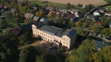 wide orbit overview drone of village ziethen castle in brandenburg germany, sunny summer day 2022. High Quality 4k Cinematic footage