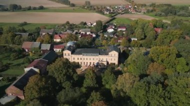wide orbit overview drone of village ziethen castle in brandenburg germany, sunny summer day 2022. High Quality 4k Cinematic footage