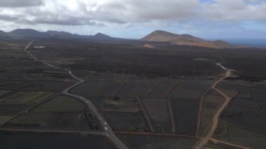 pull in drone black volcano ash track, cloudy day 2023. High Quality 4k Cinematic footage.