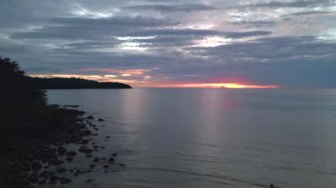 boom sliding to right drone cloudy orange sunset at paradise beach at koh kood island Thailand 2022. High Quality 4k Cinematic footage.