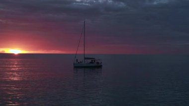 fly reverse drone cloudy orange sunset at paradise beach at koh kood island Thailand 2022. High Quality 4k Cinematic footage.