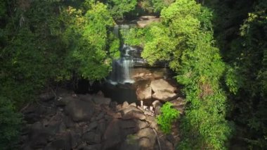 boom sliding to right drone of Huang Nam Khiao Waterfall deep in the jungle on island ko kut thailand 2022. High Quality 4k Cinematic footage.