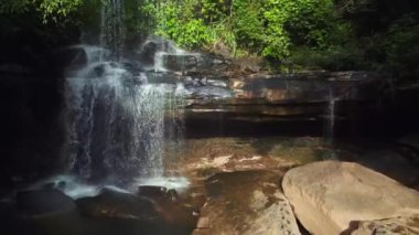 pull in drone of Huang Nam Khiao Waterfall deep in the jungle on island ko kut thailand 2022. High Quality 4k Cinematic footage.