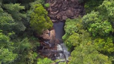 vertical birds eye view drone of Huang Nam Khiao Waterfall deep in the jungle on island ko kut thailand 2022. High Quality 4k Cinematic footage.
