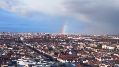Berlin üzerinde gökkuşağı, Almanya 'da yağmurlu gri bulutlu gökyüzü bölgesi mitte. sağdaki drone 4k uhd sinematik görüntüye döndür.