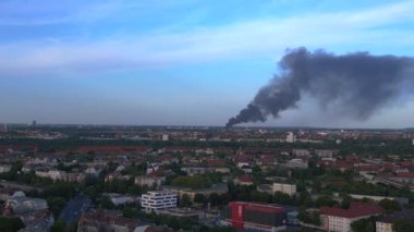 23 Mayıs 'ta Berlin' in sol insansız hava aracına dönüş. Büyük ateş siyah bulut dumanı. Alevler içinde geri dönüşüm alanı. Yukarıdan 4k Sinematik üst görünümü