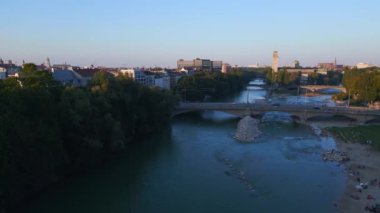 Münih nehri Isar plaj köprüsü Parkı, Almanya Bavyera, yaz açık gökyüzü akşam 23 rotasyonu sol insansız hava aracı 4k sineması
