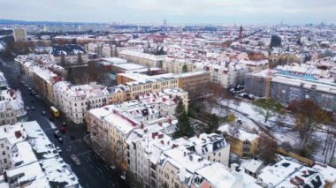 Kar yağışlı kış Berlin 'in karlı çatıları bulutlu gökyüzü. boom sağ İHA 'ya kayıyor Yüksek kalite 4k görüntü