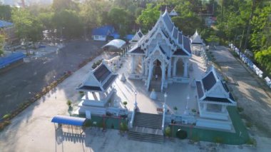 Panorama yörüngesindeki insansız hava aracı, arka planda tropikal manzaralı sakin bir Tayland tapınağı üzerinde çekim yaptı.