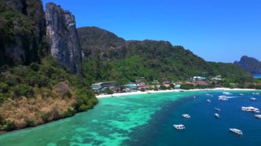 Turkuaz su, doğanın güzelliğini gösteren bir tatil köyü olan tropikal bir adayı çevrelemektedir. uçuş üstü insansız hava aracı 