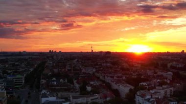 Berlin 'in bulutlu güneş doğarken hava görüntüsü. Televizyon kulesi renkli gökyüzüne karşı dikiliyor. Ters İHA uçuşu 
