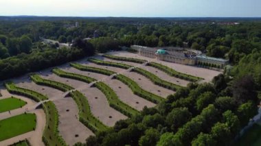 Aerial view of Potsdam sanssouci palace showing the beautiful green gardens and surrounding area on a sunny summer day. fly push forward drone 