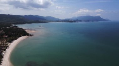 Langkawi 'de turkuaz suyla tropikal Rekreasi Kastam sahilinin havadan görünüşü. Yukarıdan insansız hava aracı görüntüleri 