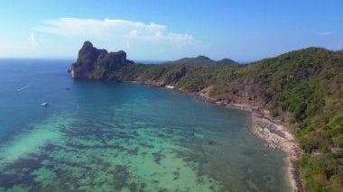 Turistler, Tayland 'daki Koh Phi Phi adası loh dalum plajında gelgitin tadını çıkarıyorlar. Uzun kuyruklu botlar dinleniyor. Yukarıdan insansız hava aracı görüntüleri 