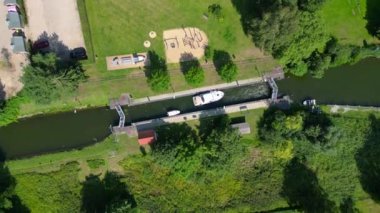 Almanya 'nın Himmelpfort kırsalında güneşli bir yaz gününde botlar tarafından kullanılan kanal kanalı manzarası. dikey kuş bakışı dron 