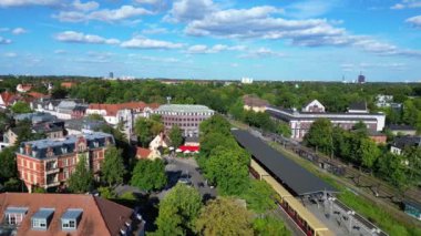Bir Avrupa şehrindeki tren istasyonunun havadan görünüşü, rayların üzerinde trenler bekliyor. Ters İHA uçuşu 