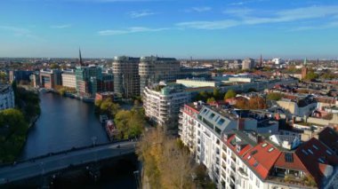 Berlin, Almanya 'da güneşli bir günde binalar ve sonbahar ağaçlarıyla çevrili bir arazinin havadan görünüşü. Yukarıdan insansız hava aracı görüntüleri 