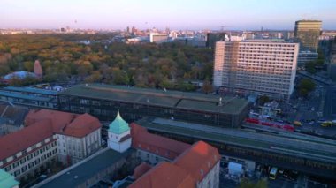 Hayvanat bahçesi tren istasyonunun ve Berlin, Almanya 'da gün batımında çevreleyen şehir manzarasının görüntüsü yükseldi. statik üç ayaklı insansız hava aracı 