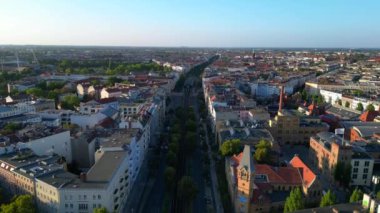 Berlin 'in yerleşim bölgesinden geçen sarı yükseltilmiş tren. İHA alçalıyor 