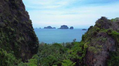 Tayland, Krabi 'deki verimli tropikal orman bitkisine bakan bir uçurumdan Railay sahilinin nefes kesici manzarası. Ters İHA uçuşu 
